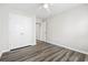 This bedroom has natural light, wood-look flooring, a ceiling fan, and a double door closet at 3725 Park Pointe Ave., Little River, SC 29566