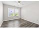 This bedroom has natural light from the two windows, a ceiling fan, and wood-look flooring at 3725 Park Pointe Ave., Little River, SC 29566