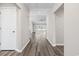 Bright hallway with wood-look floors and a view into the living room and backyard at 3725 Park Pointe Ave., Little River, SC 29566