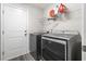 The laundry room features a gray washer and dryer with a door to the outside at 3725 Park Pointe Ave., Little River, SC 29566