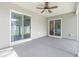 The covered patio features sliding glass doors, a ceiling fan, and a view of the backyard at 3725 Park Pointe Ave., Little River, SC 29566