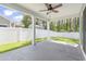 A covered patio with white pillars overlooks a well-maintained backyard and white picket fence at 3725 Park Pointe Ave., Little River, SC 29566