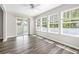 Sun-drenched sunroom boasting multiple windows and access to the outdoors at 3725 Park Pointe Ave., Little River, SC 29566