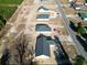 The aerial view captures new homes nestled alongside green trees and street at 375 Log Cabin Rd., Loris, SC 29569