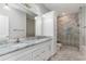 Bathroom featuring a marble top double sink vanity and a tiled shower with a glass door at 375 Log Cabin Rd., Loris, SC 29569
