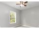 Bedroom with neutral walls, plush carpet, a ceiling fan, and a window overlooking a yard at 375 Log Cabin Rd., Loris, SC 29569