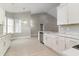 Well-lit open kitchen with stainless appliances, and white cabinetry and countertops at 375 Log Cabin Rd., Loris, SC 29569