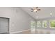 Spacious living room with vaulted ceiling, sliding glass door, and modern ceiling fan at 375 Log Cabin Rd., Loris, SC 29569