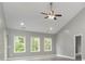 Bright living room with vaulted ceiling, large windows, and modern ceiling fan at 375 Log Cabin Rd., Loris, SC 29569