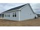 This home's side exterior showcases the light blue siding and black roof at 375 Log Cabin Rd., Loris, SC 29569