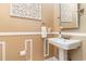 Stylish powder room boasts modern sink, decorative wall art, and neutral color palette, offering a sophisticated touch at 3757 Kingsley Dr., Myrtle Beach, SC 29588