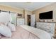 Relaxing bedroom showcases a plush bed, dresser, sliding barn door into bathroom, and TV for comfortable living at 3757 Kingsley Dr., Myrtle Beach, SC 29588