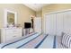 Comfortable bedroom features a striped bed, closet, and TV, offering a relaxing and functional space at 3757 Kingsley Dr., Myrtle Beach, SC 29588