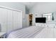 This bedroom includes a TV and dresser, closet, and is decorated in light colors at 3757 Kingsley Dr., Myrtle Beach, SC 29588