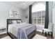 Cozy bedroom features a queen bed, vaulted ceilings, and shuttered window, creating a peaceful sanctuary at 3757 Kingsley Dr., Myrtle Beach, SC 29588