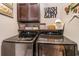 Laundry room with modern washer and dryer set and decorative shelving at 3757 Kingsley Dr., Myrtle Beach, SC 29588