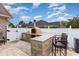 Outdoor kitchen with a built-in pizza oven and bar seating, perfect for entertaining at 3757 Kingsley Dr., Myrtle Beach, SC 29588