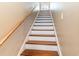 Staircase with wooden handrail and white trim leading to the upper level at 3757 Kingsley Dr., Myrtle Beach, SC 29588