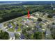 Aerial view showcases a residential neighborhood with pond and wooded surroundings at 40 Little Peru Ct., Georgetown, SC 29440