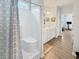 Bright bathroom with shower and tub combination, white vanity, and wood-look tile floors at 40 Little Peru Ct., Georgetown, SC 29440