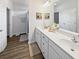 Bright bathroom features double vanity, white cabinets, and wood-look tile flooring at 40 Little Peru Ct., Georgetown, SC 29440