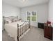 Comfortable bedroom with a metal-frame bed, large window, and neutral tones at 40 Little Peru Ct., Georgetown, SC 29440