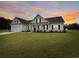 Charming home features a well-manicured lawn, black shutters, and an attached garage in a suburban neighborhood at 40 Little Peru Ct., Georgetown, SC 29440