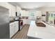 Bright, modern kitchen with white cabinets, stainless steel appliances, and a large quartz island at 40 Little Peru Ct., Georgetown, SC 29440