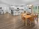 Open kitchen and dining area with bright, white cabinets, an island, and a wood dining set at 40 Little Peru Ct., Georgetown, SC 29440