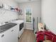 Functional laundry room includes washer, dryer, storage shelves, and a bright window at 40 Little Peru Ct., Georgetown, SC 29440