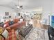 Spacious living room with stylish decor, a ceiling fan, and an open view of the kitchen and dining area at 40 Little Peru Ct., Georgetown, SC 29440