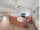 Bright living room with a vaulted ceiling, wood floors, and access to the dining area and kitchen at 40 Little Peru Ct., Georgetown, SC 29440