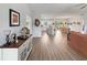 Open-concept living space with wood floors, flowing into a bright kitchen and dining area at 40 Little Peru Ct., Georgetown, SC 29440