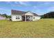 Spacious backyard with a screened-in porch on a well-maintained lawn at 40 Little Peru Ct., Georgetown, SC 29440