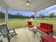 Relaxing screened porch overlooking serene pond views and comfortable seating arrangement at 40 Little Peru Ct., Georgetown, SC 29440