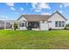 Grassy backyard featuring a covered patio, outdoor kitchen, and pergola at 400 Palo Verde Dr., Myrtle Beach, SC 29579