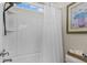 Bright bathroom features a shower with a white shower curtain and a decorative art print at 400 Palo Verde Dr., Myrtle Beach, SC 29579