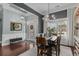 Cozy dining room featuring a table, front door view, and elegant chandelier at 400 Palo Verde Dr., Myrtle Beach, SC 29579