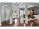 Inviting foyer with elegant chandelier, wood floors, and an arched doorway leading to other rooms at 400 Palo Verde Dr., Myrtle Beach, SC 29579