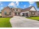 Charming home featuring stone accents, a three-car garage, and a well-manicured lawn at 400 Palo Verde Dr., Myrtle Beach, SC 29579