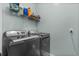 Laundry room with shelving and modern washer and dryer units at 400 Palo Verde Dr., Myrtle Beach, SC 29579