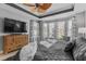 Well-lit main bedroom with a ceiling fan, dresser, large windows, and neutral decor at 400 Palo Verde Dr., Myrtle Beach, SC 29579