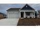 Charming single-story home with gray siding, an attached garage, and a welcoming front porch at 402 Glade Ct., Loris, SC 29569