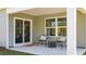 Cozy covered patio with outdoor seating, perfect for relaxing or entertaining guests at 410 Glade Ct., Loris, SC 29569
