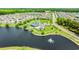 Aerial view of a community clubhouse, pool, tennis courts, and scenic pond with fountain at 448 Papyrus Circle # 448, Little River, SC 29566