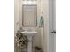 Half bath features a pedestal sink with a framed mirror and neutral paint at 448 Papyrus Circle # 448, Little River, SC 29566
