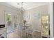This dining area features hardwood floors, dining table and chairs, and updated light fixture at 448 Papyrus Circle # 448, Little River, SC 29566
