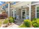 Charming front porch with rocking chairs, decorative accents, and beautifully landscaped yard at 448 Papyrus Circle # 448, Little River, SC 29566