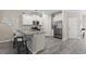 Charming kitchen features an island with barstool seating, stainless appliances, and light wood floors at 448 Papyrus Circle # 448, Little River, SC 29566