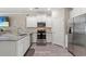 Bright kitchen with stainless appliances, white cabinets, and a mosaic tile backsplash at 448 Papyrus Circle # 448, Little River, SC 29566